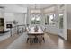 Inviting dining area with hardwood floors, a modern chandelier, fireplace, and views to backyard at 8130 Cassian Ct, Las Vegas, NV 89129