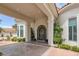Elegant home entrance featuring a beautifully crafted wrought iron door, portico, meticulous landscaping, and covered entry at 8130 Cassian Ct, Las Vegas, NV 89129