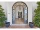 Elegant home entrance with ornate iron doors, decorative chandelier, and views into the living room at 8130 Cassian Ct, Las Vegas, NV 89129