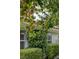 Charming exterior details showcase a fruit tree, lush landscaping, and architectural beauty, adding character to the property at 8130 Cassian Ct, Las Vegas, NV 89129