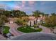Beautiful home boasts a circular driveway, mature landscaping, and a welcoming entrance, enhancing its curb appeal and charm at 8130 Cassian Ct, Las Vegas, NV 89129
