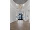 Elegant foyer featuring herringbone wood floors, decorative chandelier, and arched entryways at 8130 Cassian Ct, Las Vegas, NV 89129