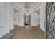 Grand foyer with herringbone floors, decorative chandelier, and open archways leading to living spaces at 8130 Cassian Ct, Las Vegas, NV 89129