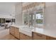 Bright kitchen showcases a farmhouse sink, white countertops, and views of the outdoor pool area at 8130 Cassian Ct, Las Vegas, NV 89129