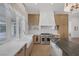 Bright kitchen with white countertops, stainless steel appliances, custom cabinetry, and farmhouse sink at 8130 Cassian Ct, Las Vegas, NV 89129