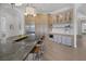 Open kitchen featuring a large island with sink, stainless steel appliances, custom cabinets, and hardwood floors at 8130 Cassian Ct, Las Vegas, NV 89129