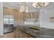 Gourmet kitchen features stainless steel appliances, custom cabinets, built-in pantry, and a large center island at 8130 Cassian Ct, Las Vegas, NV 89129