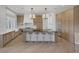 Beautiful kitchen with a large island, bar stool seating, wooden cabinetry, and modern appliances at 8130 Cassian Ct, Las Vegas, NV 89129