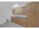 Laundry room featuring tiled floors, sink, and lots of storage cabinets at 8130 Cassian Ct, Las Vegas, NV 89129