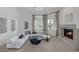 Bright living room featuring a modern fireplace, large sectional sofa, and sunlit windows with drapes at 8130 Cassian Ct, Las Vegas, NV 89129