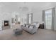 Spacious main bedroom with a fireplace, seating area, and plenty of natural light at 8130 Cassian Ct, Las Vegas, NV 89129