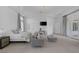 Spacious main bedroom featuring a seating area, TV, and access to a balcony at 8130 Cassian Ct, Las Vegas, NV 89129