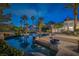 Backyard pool with mature landscaping, and steps that lead to bar stools in the pool at 8130 Cassian Ct, Las Vegas, NV 89129