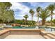 Resort-style pool featuring lush landscaping, rock accents, and a charming bridge feature at 8130 Cassian Ct, Las Vegas, NV 89129