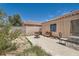 Outdoor space includes a cozy seating area on the patio, desert landscaping and block wall at 821 Tollbrook Way, Henderson, NV 89011