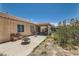Spacious backyard with partially covered patio area, desert landscaping, and outdoor seating at 821 Tollbrook Way, Henderson, NV 89011