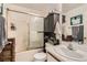 Bathroom featuring a shower-tub combination, vanity, and dark wood cabinet for storage at 821 Tollbrook Way, Henderson, NV 89011
