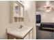Bathroom featuring a vanity with storage, mirror, and access to the Primary bedroom at 821 Tollbrook Way, Henderson, NV 89011