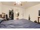Bedroom features carpet, large bed, and access to a closet and bathroom at 821 Tollbrook Way, Henderson, NV 89011