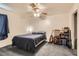Simple bedroom with a cozy bed, neutral carpet, and a ceiling fan at 821 Tollbrook Way, Henderson, NV 89011