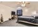 Bedroom features carpet, ceiling fan and large bed, and a side table at 821 Tollbrook Way, Henderson, NV 89011