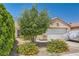 Charming single-story home with desert landscaping featuring shrubbery and gravel at 821 Tollbrook Way, Henderson, NV 89011