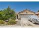 Charming single-story home with a tile roof, desert landscaping, and a covered vehicle in the driveway at 821 Tollbrook Way, Henderson, NV 89011