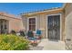 Inviting front porch with a seating area and decorative metal door at 821 Tollbrook Way, Henderson, NV 89011