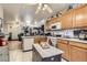 Functional kitchen with laminate cabinets, an island, and a breakfast bar at 821 Tollbrook Way, Henderson, NV 89011