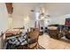 Open-concept living room with tile flooring, ceiling fan, and comfortable seating arrangement at 821 Tollbrook Way, Henderson, NV 89011