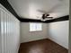 Bright bedroom with wood-look flooring, wainscoting and ceiling fan, offering comfort and style at 8237 Cline Mountain St, Las Vegas, NV 89131