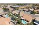 An aerial view of homes showcasing desert landscaping, tile roofs, pools, and desert landscaping at 8714 Las Posas Ave, Las Vegas, NV 89147