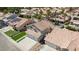 An aerial view of a single-Gathering house with a spacious backyard, a two-car garage, and a tiled roof at 8714 Las Posas Ave, Las Vegas, NV 89147