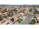 An aerial view of homes showcasing a tile roof, solar panels, desert landscaping, and community pools at 8714 Las Posas Ave, Las Vegas, NV 89147