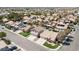 Aerial view of homes featuring desert landscaping, tile roofs, and community pools in suburban neighborhood at 8714 Las Posas Ave, Las Vegas, NV 89147