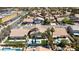 Aerial view of neighborhood highlighting well-maintained houses with desert landscaping, tile roofs, and community pools at 8714 Las Posas Ave, Las Vegas, NV 89147