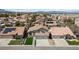 Aerial view of a residential neighborhood showcasing well-maintained homes with tile roofs and landscaping at 8714 Las Posas Ave, Las Vegas, NV 89147