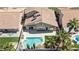Aerial view of a backyard featuring a swimming pool, and lush landscaping, perfect for relaxation and entertaining at 8714 Las Posas Ave, Las Vegas, NV 89147