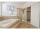 Bathroom features a glass enclosed shower, soaking tub, and closet at 8714 Las Posas Ave, Las Vegas, NV 89147