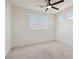 Bright bedroom with white walls, plush carpet, and natural light from the large window at 8714 Las Posas Ave, Las Vegas, NV 89147