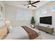 Bedroom features a ceiling fan, tv and neutral decor perfect for relaxing at 8714 Las Posas Ave, Las Vegas, NV 89147