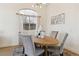Bright dining room features modern chandelier and a large window at 8714 Las Posas Ave, Las Vegas, NV 89147