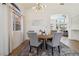 Bright dining room with white trim, a modern chandelier, and hardwood floors at 8714 Las Posas Ave, Las Vegas, NV 89147