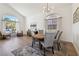 Open-concept dining room boasts hardwood floors and an elegant chandelier at 8714 Las Posas Ave, Las Vegas, NV 89147