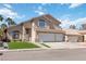 View of two-story home with a three-car garage and manicured lawn at 8714 Las Posas Ave, Las Vegas, NV 89147