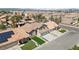 Inviting single-Gathering home with desert landscaping, green lawn, tile roof, and two-car garage at 8714 Las Posas Ave, Las Vegas, NV 89147