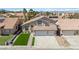 Charming home with a well-manicured lawn and attached three-car garage at 8714 Las Posas Ave, Las Vegas, NV 89147
