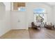 Bright, airy foyer featuring double doors, tile flooring, and a seating area by a window at 8714 Las Posas Ave, Las Vegas, NV 89147