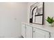 Hallway features a white cabinet with decorative art and a potted plant at 8714 Las Posas Ave, Las Vegas, NV 89147