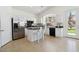 Kitchen features white cabinets, stainless steel appliances, and a breakfast bar at 8714 Las Posas Ave, Las Vegas, NV 89147